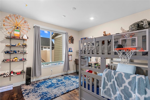 bedroom with baseboards and wood finished floors