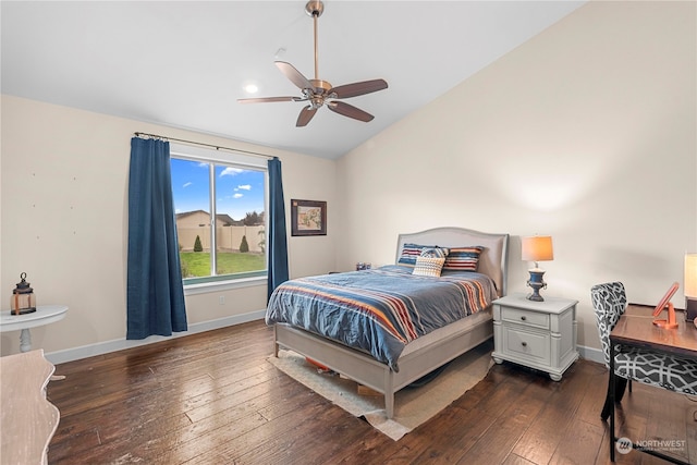 bedroom with ceiling fan, baseboards, lofted ceiling, and hardwood / wood-style floors