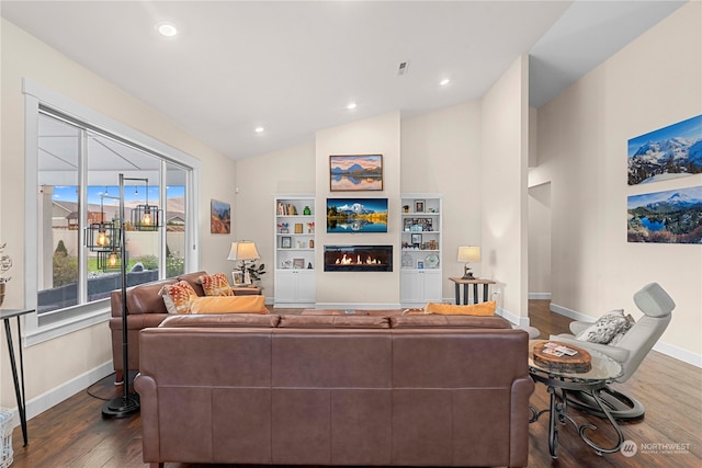 living room featuring a glass covered fireplace, recessed lighting, baseboards, dark wood-style flooring, and vaulted ceiling