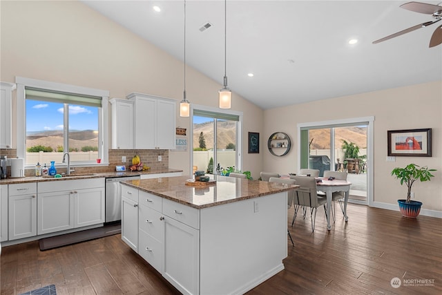 kitchen featuring a wealth of natural light, visible vents, dishwasher, and a sink