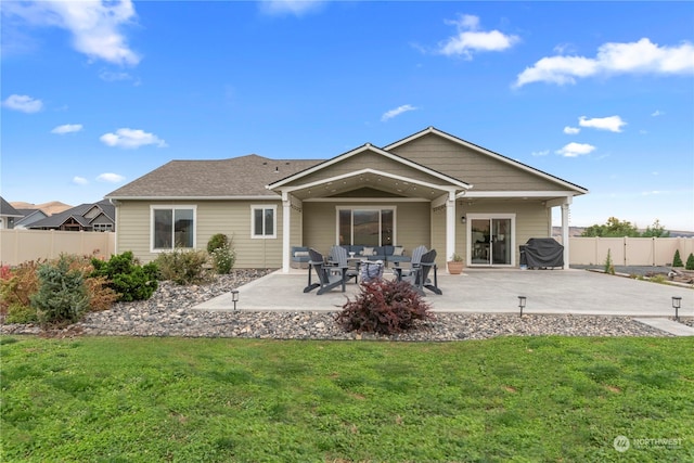 back of property with a patio area, a yard, and fence