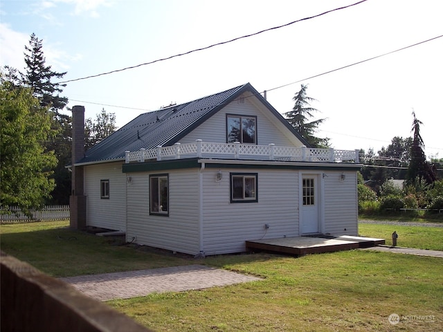 rear view of house with a yard