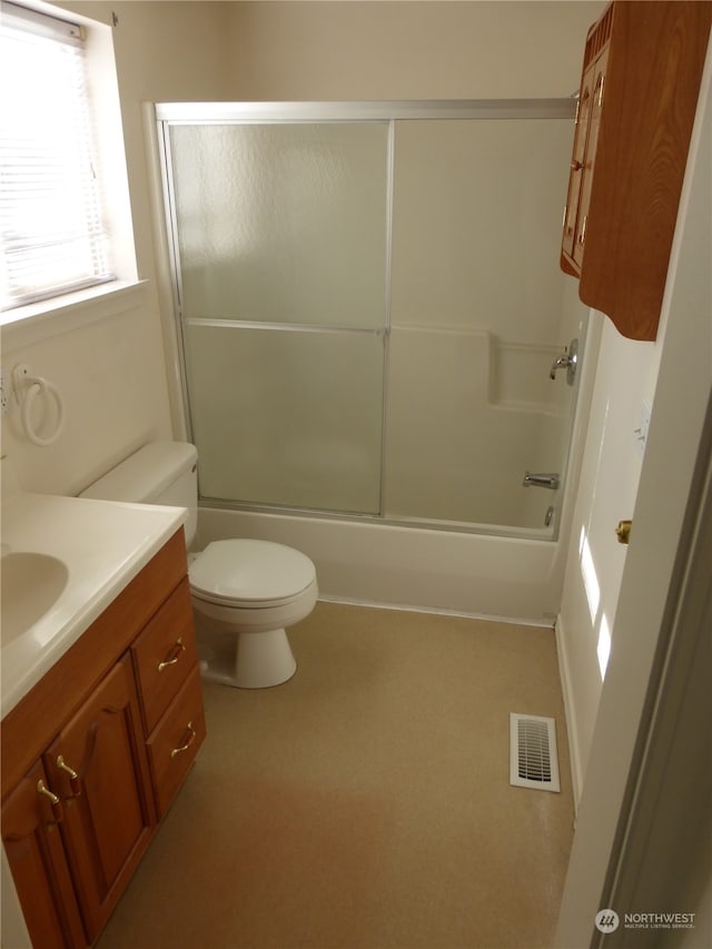 full bathroom with vanity, toilet, and bath / shower combo with glass door