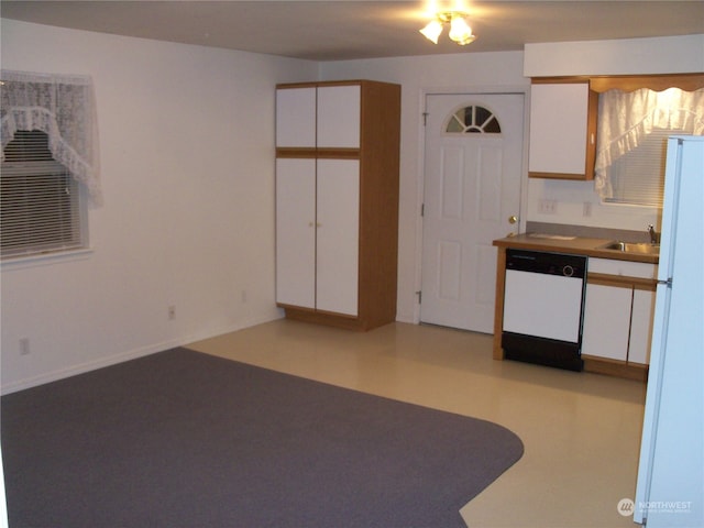 interior space with white cabinets, white appliances, and sink