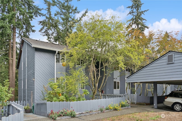 view of property exterior with a carport