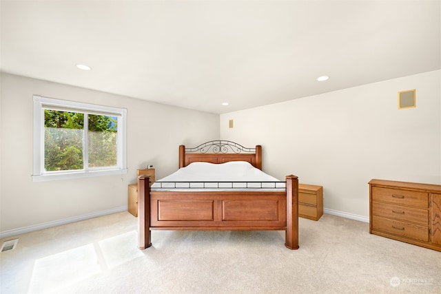 bedroom with light colored carpet