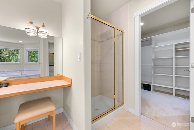 bathroom with a notable chandelier, an enclosed shower, and tile patterned floors