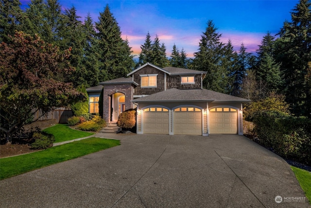 view of front of home featuring a lawn and a garage