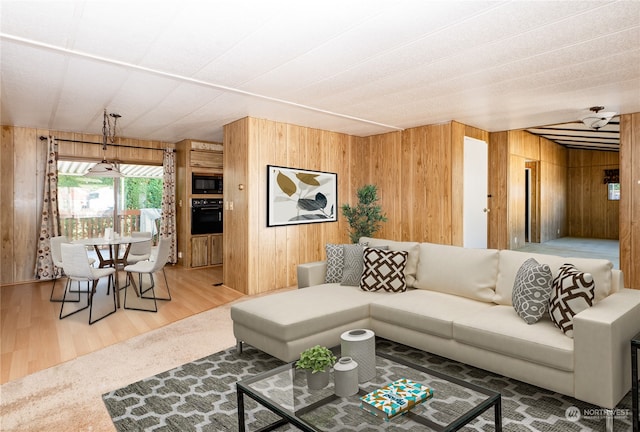 living room featuring wooden walls and hardwood / wood-style floors