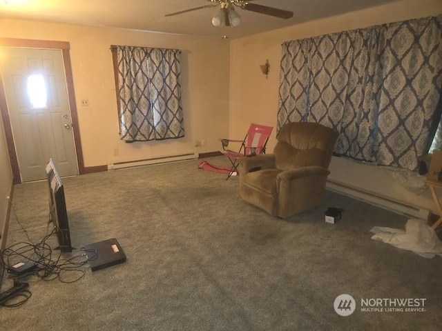 sitting room with carpet floors, a baseboard heating unit, and ceiling fan