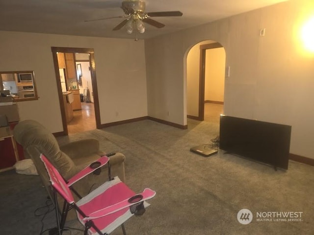 living room with carpet floors and ceiling fan