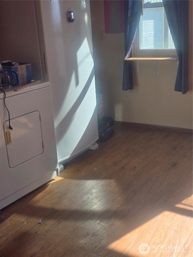 interior space featuring baseboards, washer / clothes dryer, and hardwood / wood-style floors