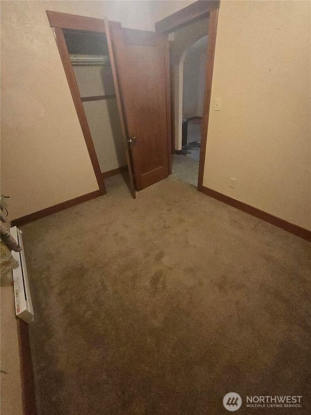 unfurnished bedroom with light carpet and baseboards