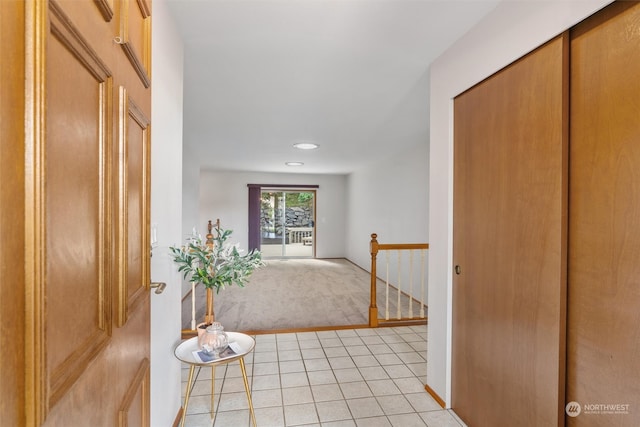 hall featuring light tile patterned flooring