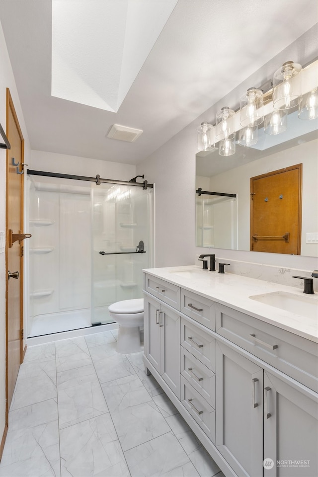 bathroom featuring vanity, toilet, and an enclosed shower