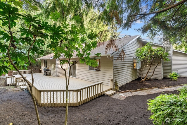 rear view of property with a wooden deck