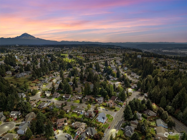 aerial view at dusk featuring a mountain view