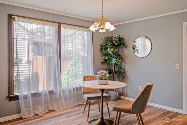 dining space featuring light wood-type flooring, a chandelier, and a wealth of natural light