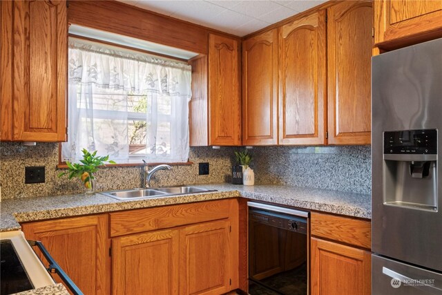 kitchen featuring stainless steel refrigerator with ice dispenser, backsplash, sink, and dishwasher