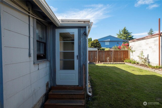 doorway to property featuring a yard