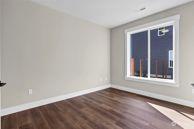 unfurnished room featuring dark hardwood / wood-style flooring