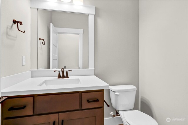 bathroom with toilet and vanity