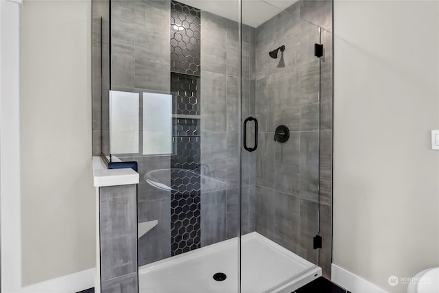 bathroom featuring toilet and an enclosed shower