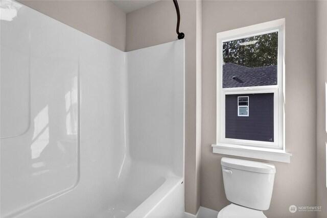 bathroom featuring  shower combination and toilet