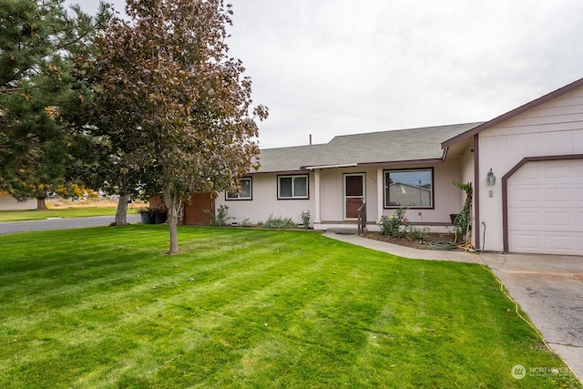 ranch-style house featuring a garage and a front lawn