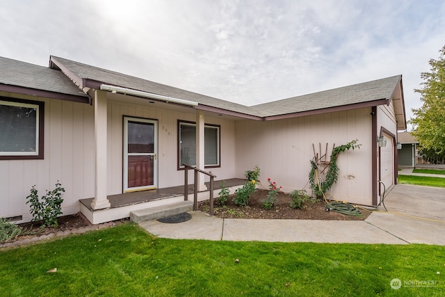 ranch-style house featuring a garage and a front lawn