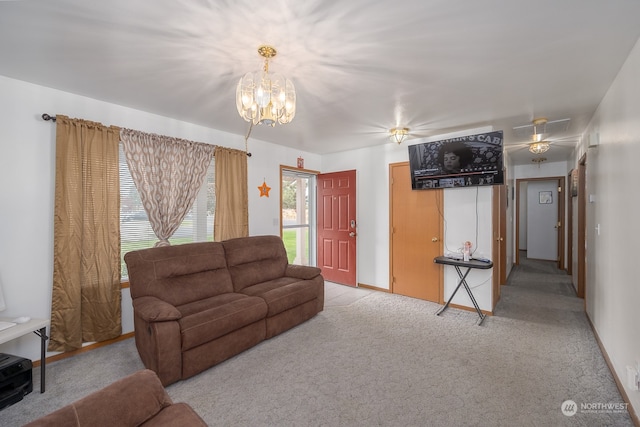 living room featuring light carpet and a chandelier