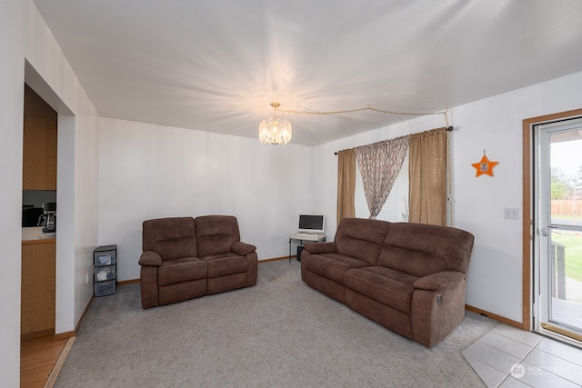 carpeted living room featuring an inviting chandelier