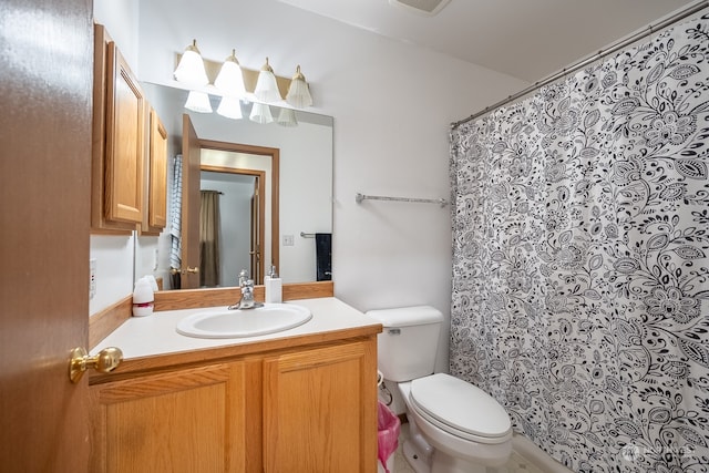 bathroom featuring vanity, toilet, and curtained shower