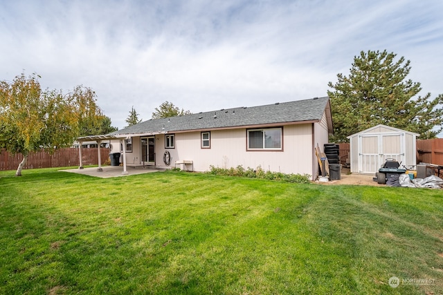 back of property featuring a storage unit, a lawn, and a patio area