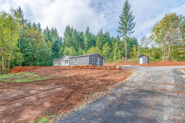 view of front of home featuring a shed