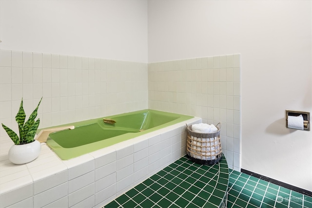 bathroom featuring a relaxing tiled tub and tile patterned floors