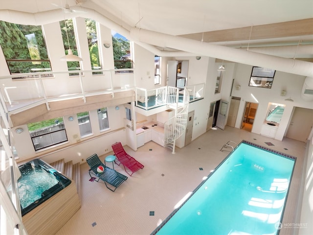 interior space with ceiling fan and an AC wall unit