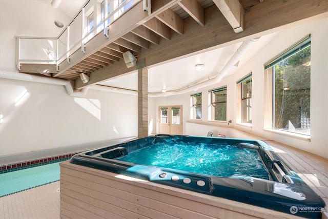 view of pool with an indoor hot tub