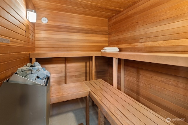 view of sauna / steam room featuring wooden walls and wooden ceiling