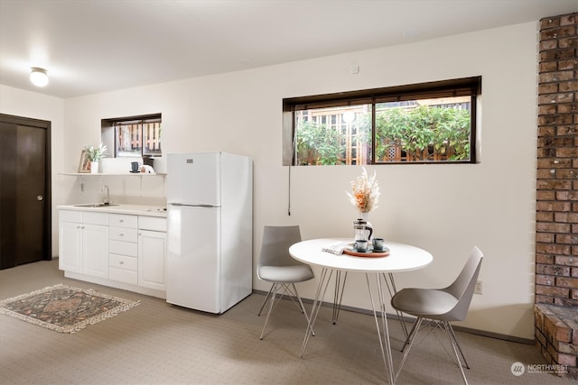 carpeted dining room with sink