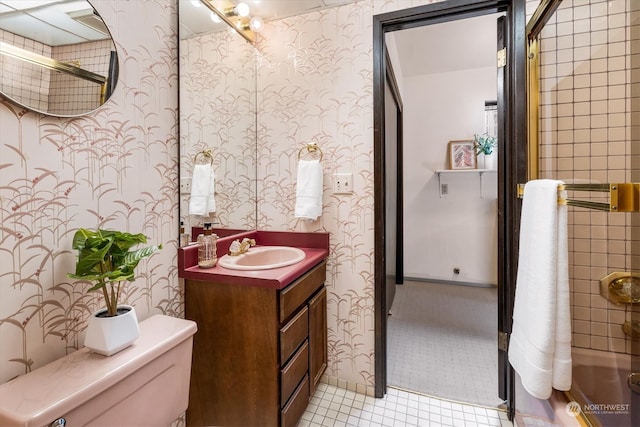 bathroom featuring tile patterned flooring, vanity, and toilet