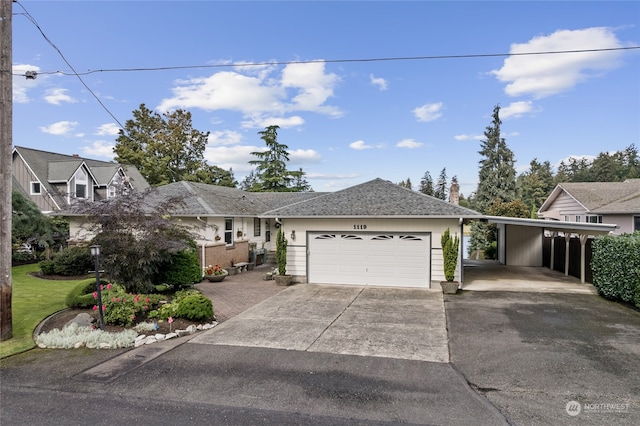 view of front facade with a carport and a garage