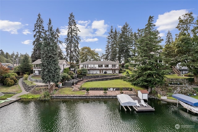 view of dock featuring a water view and a yard