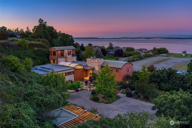 aerial view at dusk with a water view