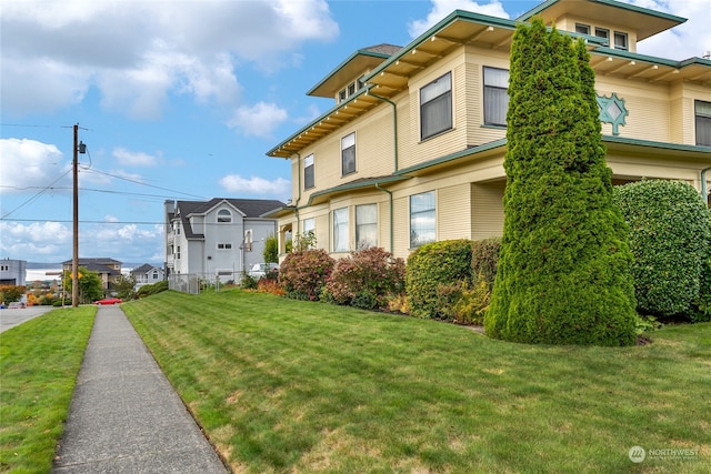 view of property exterior with a yard