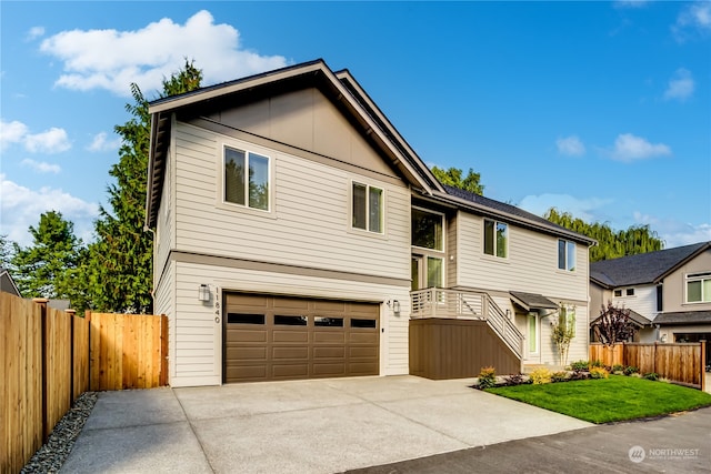 bi-level home featuring a garage and a front lawn