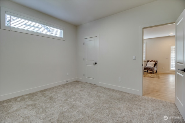 unfurnished bedroom featuring light colored carpet