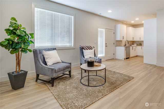 sitting room featuring light hardwood / wood-style flooring and sink