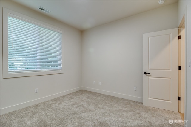 empty room featuring light carpet