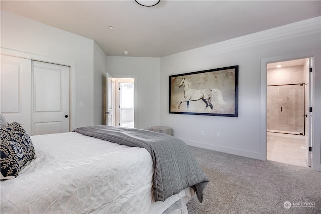 bedroom with carpet, ensuite bath, and a closet